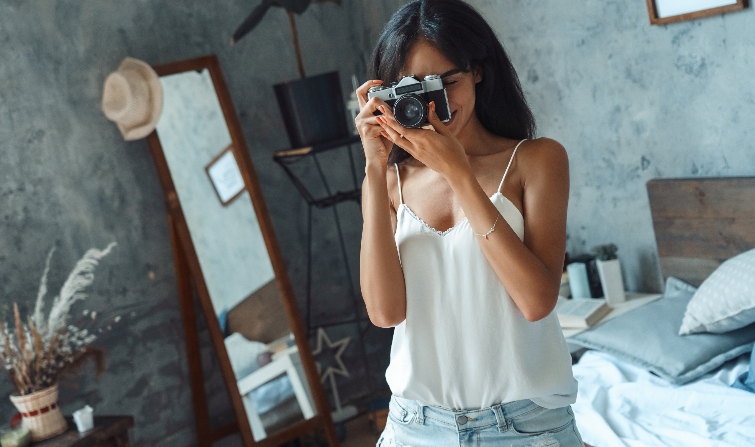 A woman taking photographs in a calm everyday setting, capturing simple moments like coffee, streets, or light, representing creative and mindful living through photography as a hobby.